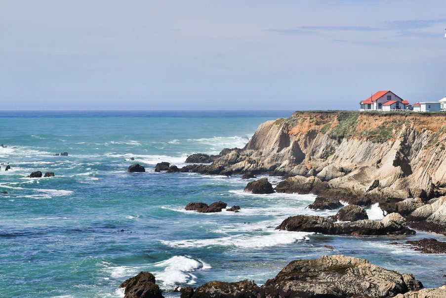 light house overlooks ocean coast