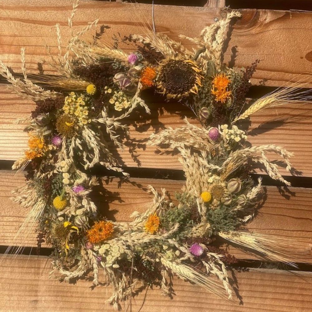 a wreath sits against a wooden background