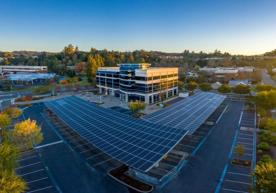 aerial view of business parking lot with solar panel roof